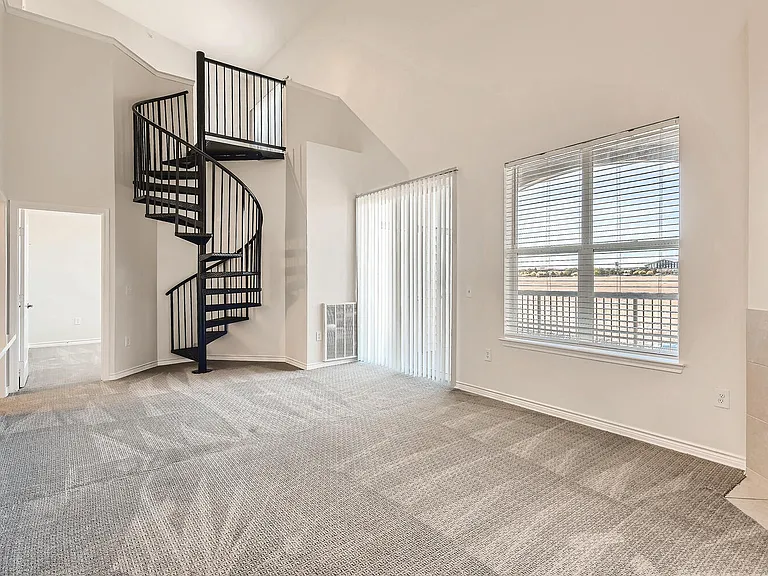 A Living Room with a Spiral Staircase at Fox Run Lofts