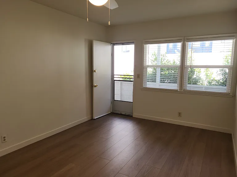 Bedroom with large windows and back door