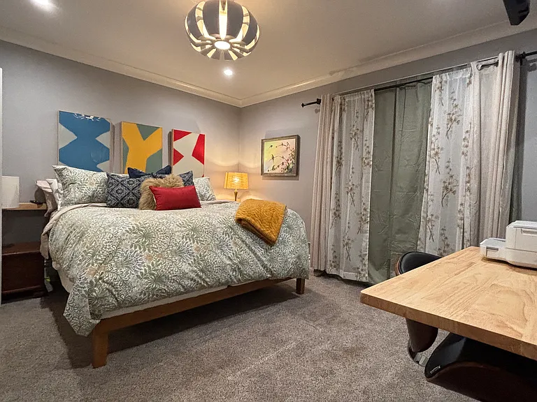 The room is adorned with a stunning, one-of-a-kind light fixture, wall shelves by the bed for your nighttime essentials. Lamps, dressers, and a large, modern closet with ample shelving ensure both functionality and beauty. Black out curtains for sleep in.