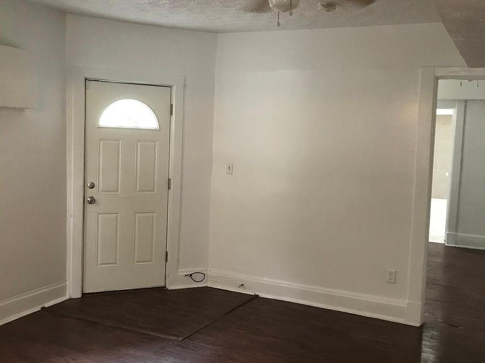 Living room with South outside door. Door to bedroom/bathroom on right
