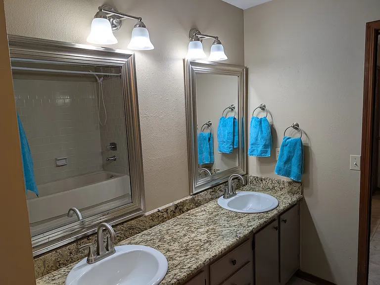 View of the tiled shower surround from the mirror reflection