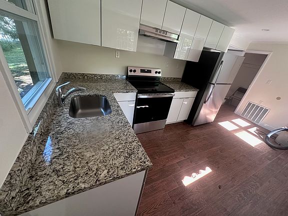 All new cabinets, countertop, GE stove and refrigerator.