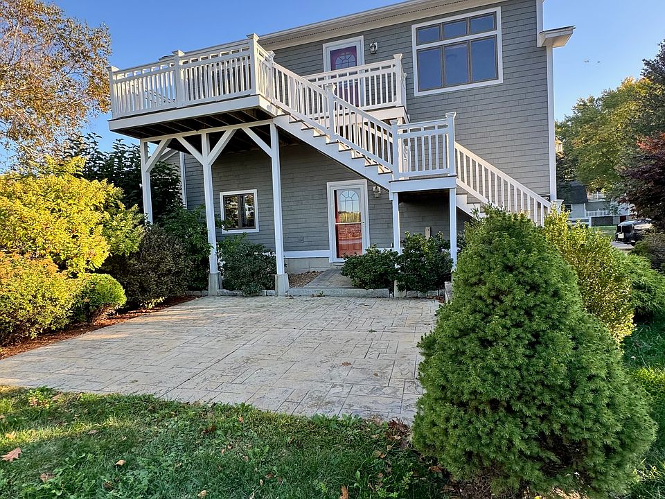 View of unit (from the water) showing the private patio and 2nd-floor balcony.