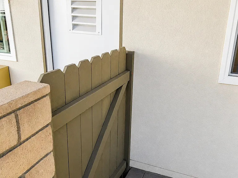 Welcoming front entry with gated patio area and convenient access to the unit.