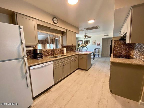 Newly remodeled kitchen with Granite Slab countertops, double sink with a disposal, brand new faucet, shoulder-high oven, tube lighting, and this brand new gorgeous rustic wood-like tile flooring.