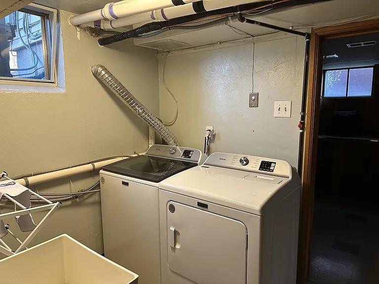 Utility room with newer washer and dryer.