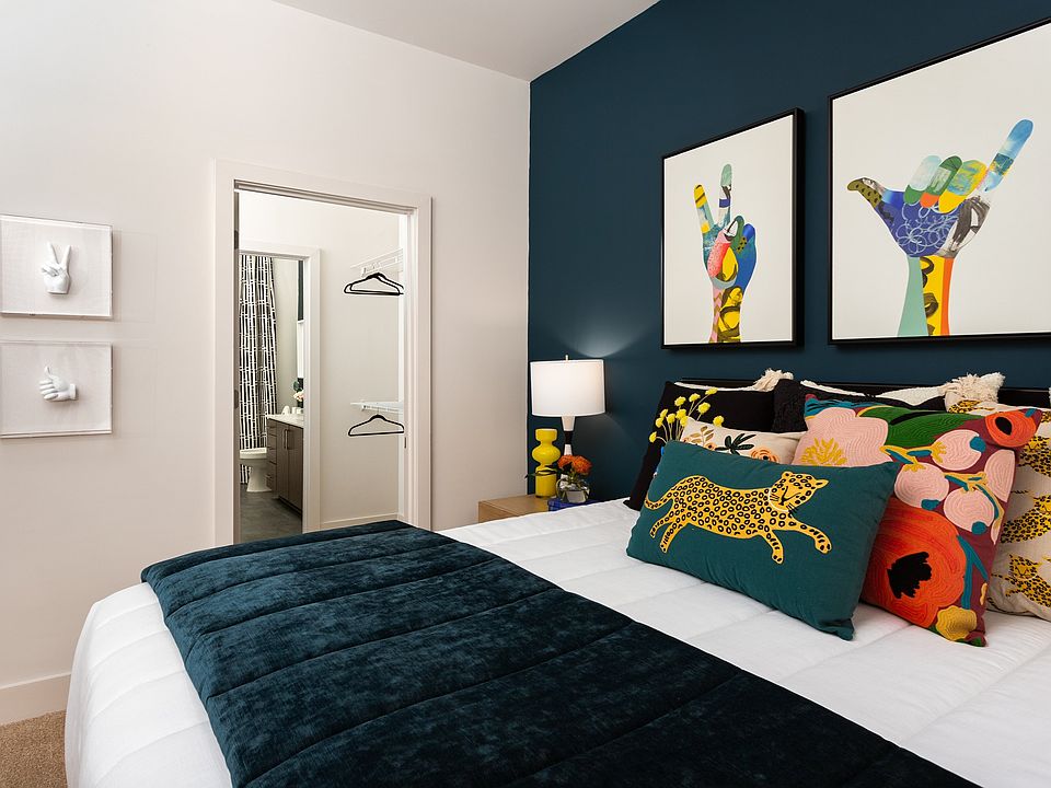 Colorful Bedroom with Accent Pillows and Ensuite Bathroom Access