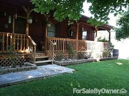 Yard is fully landscaped, with mature shade trees.