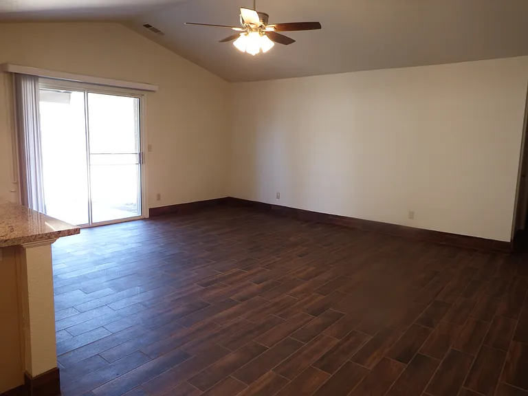 Enter from front door into spacious and bright living room with sliding patio door that leads to a large landscaped backyard with timed sprinklers.