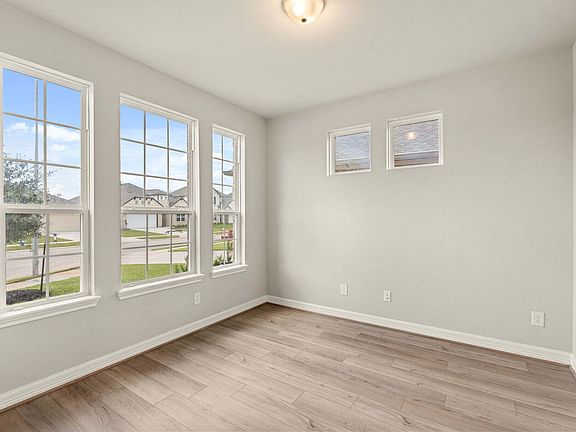 The home office features French doors, beautiful floors and large windows that give a fresh feel, th