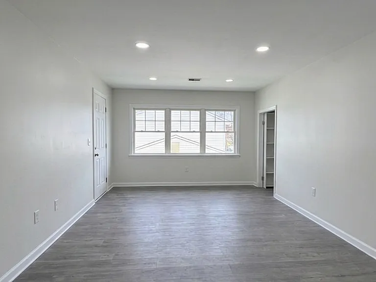 Large Living room with two closets and space for a dining area.