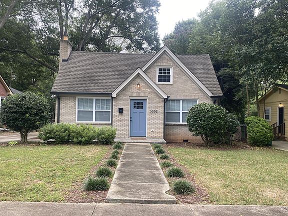 Front of brick cottage home in winter