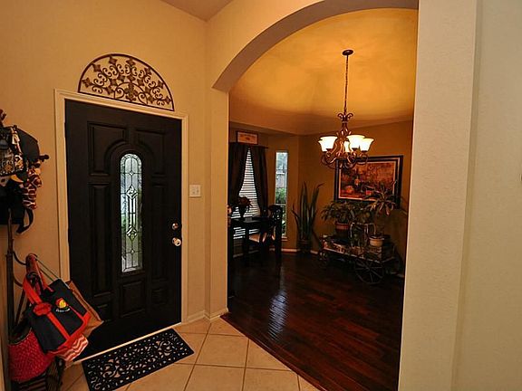 New front door with glass. Foyer opens to the formal dining/study/formal sitting area.