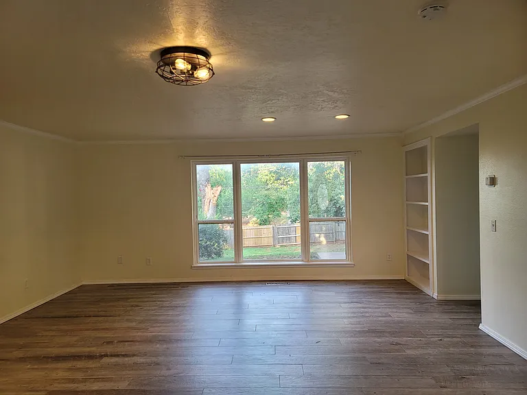Welcome home! Enjoy this open living room with built in book case and view of the big backyard.