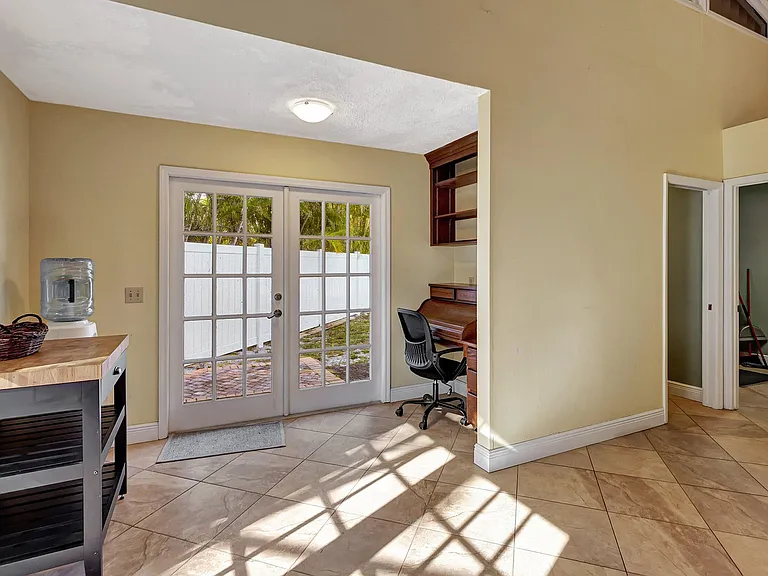 office space, doors to a fenced side yard