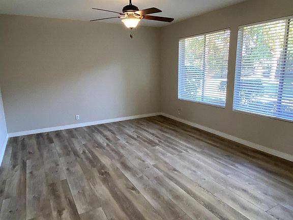 Living room with double windows facing greenbelt