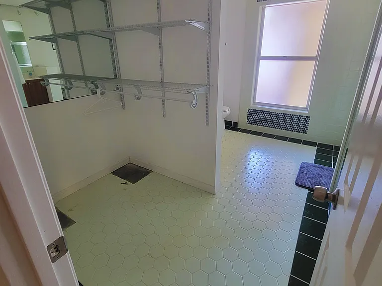 Spacious storage area with hanging hooks for clothes and personal belongings.