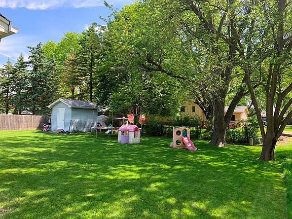 Spacious yard with deck and shed.