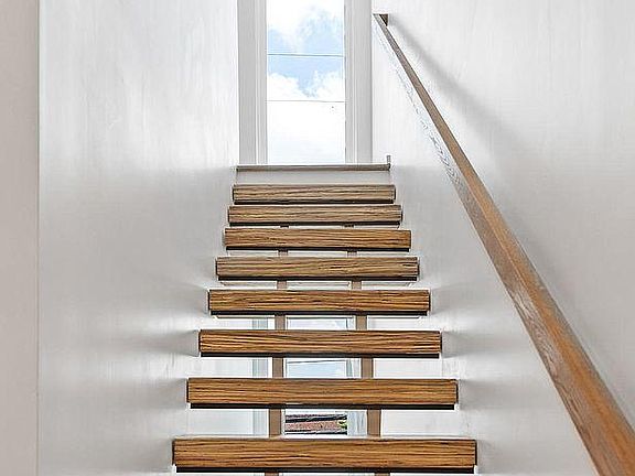 Open staircase provides great lighting between the second and third floors.