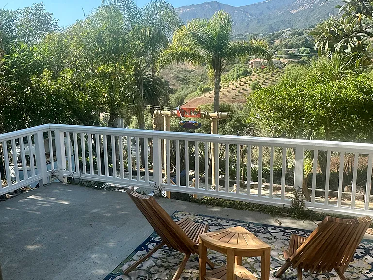 french doors open from living room to your private deck with sweeping mountain views