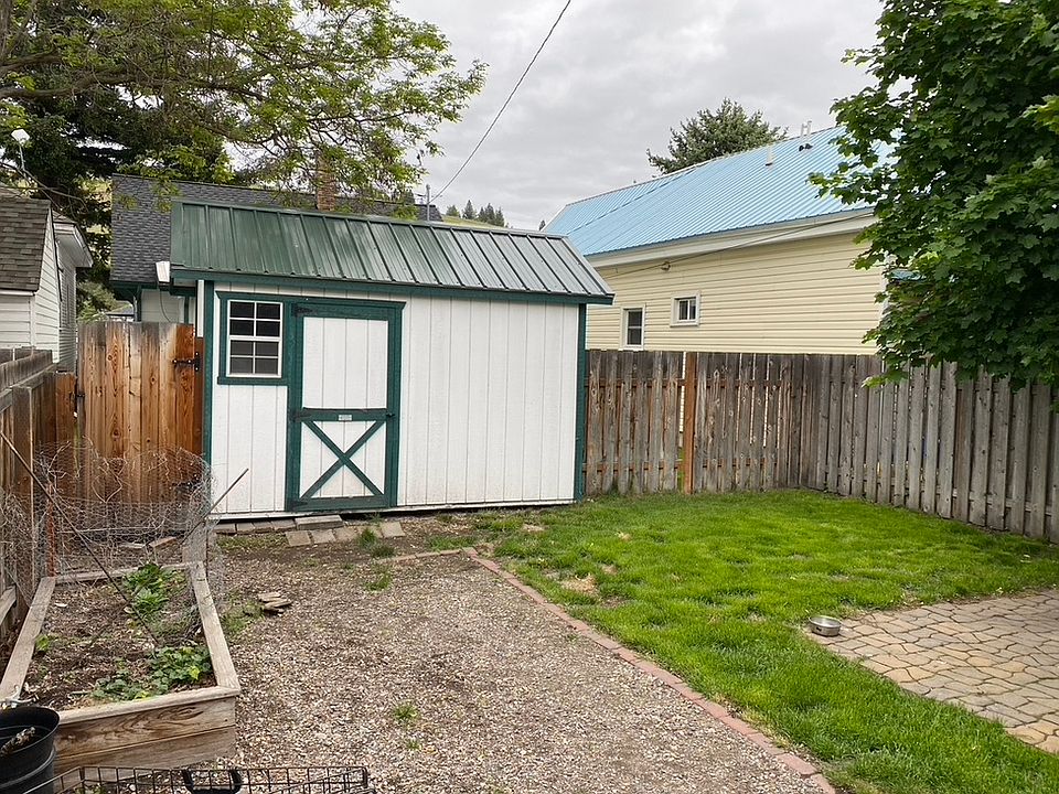 Shed, extended driveway, planter box, yard, small paver patio.