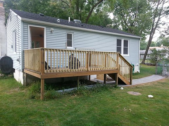 back of house with deck