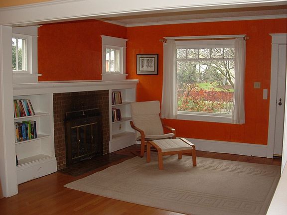 Living room features fireplace, built-in bookshelves, and oak floors.