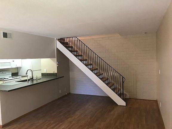 Living room with stairs to second floor bedrooms & bath