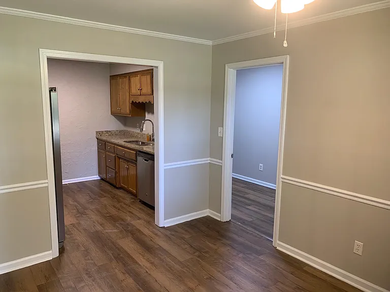 From Dining room looking into kitchen and utility room on right. The Utility room has a garage entrance.