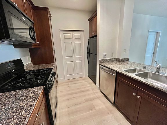 Kitchen includes 4 burners stove/oven top of range microwave dishwasher and refrigerator