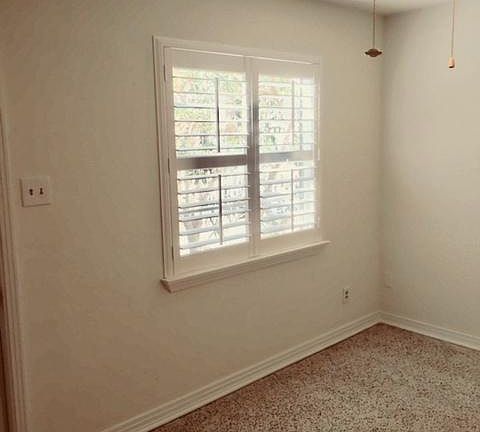 Living room has new ceiling fan and custom window shutters
