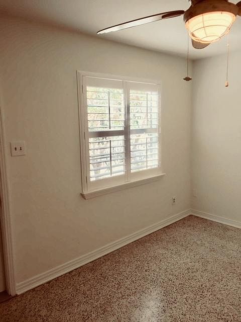 Living room has new ceiling fan and custom window shutters