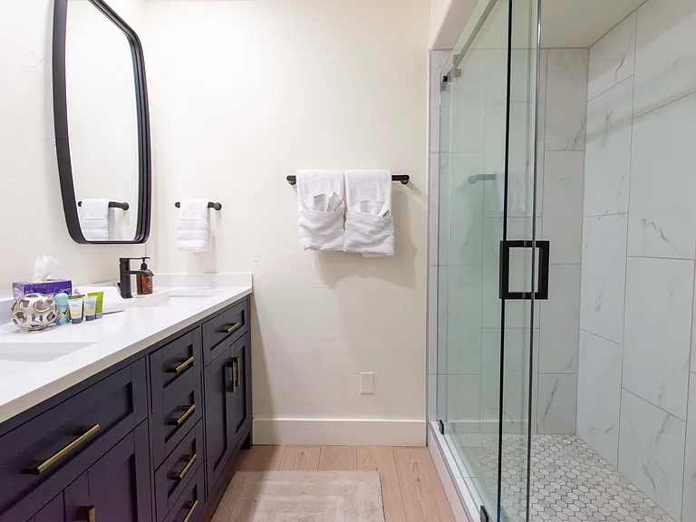 Third bathroom with dual vanity and shower