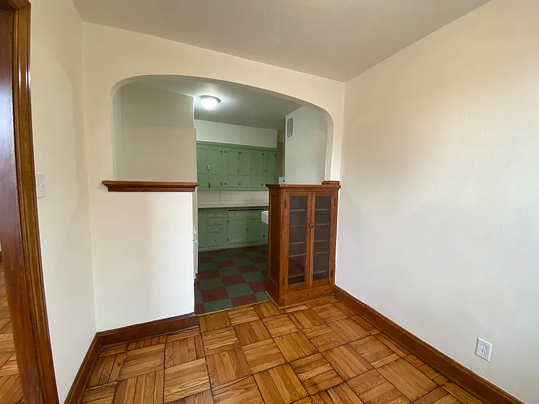 As we enter the kitchen, you will find the preserved historic details create a warm, nostalgic atmosphere while still offering practical storage and workspace.