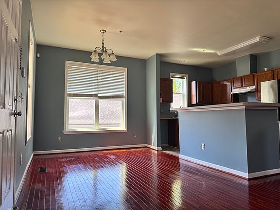 Open, airy layout with rich hardwood floors and great natural light. The space flows seamlessly between the dining and kitchen areas