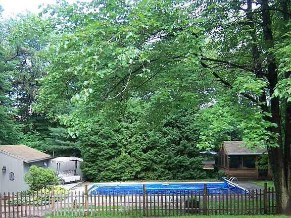 inground pool with screen house and large shed