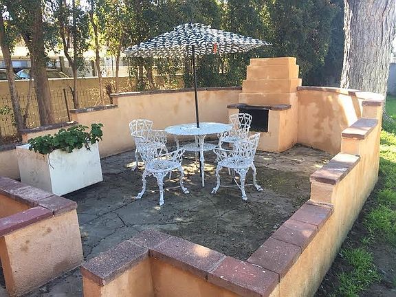 Backyard Bar B Que area and open outdoor fire pit.