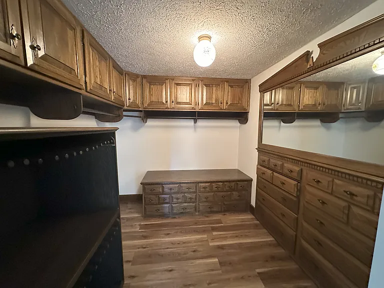 Master bedroom closet with custom built ins