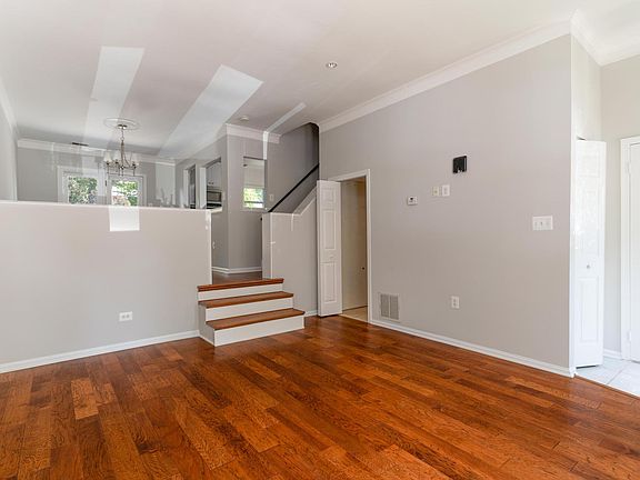 Walk into sunken living room with high ceilings.