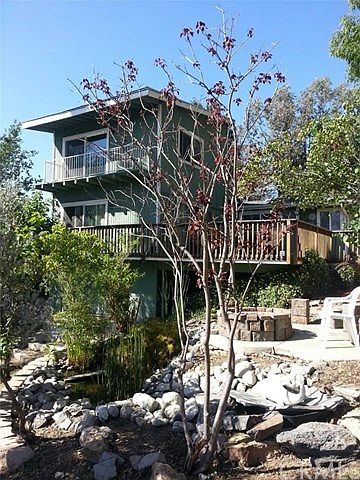 Built against a gentle slope.  The bottom level is a very spacious basement/storage room.