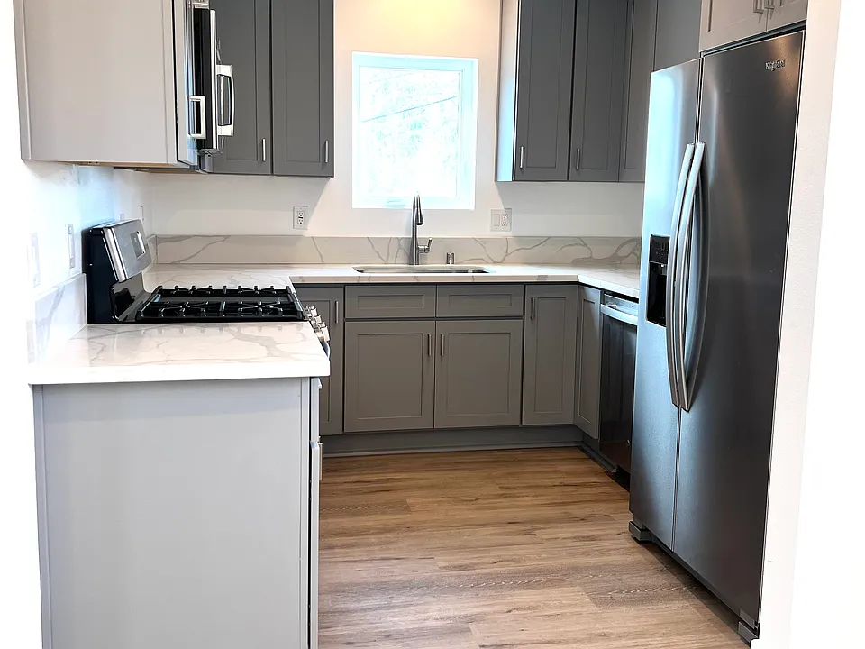 Kitchen with all new stainless steel appliances and lots of storage with upper and lower cabinet storage.