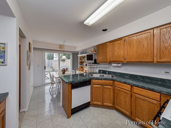 Large eat-in kitchen with sliders opening to concrete patio for your summertime outdoor entertaining