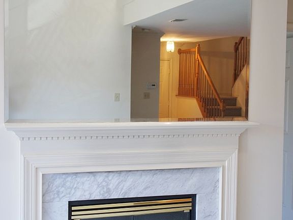 Marble Encased Fireplace w/ Wall Mirror