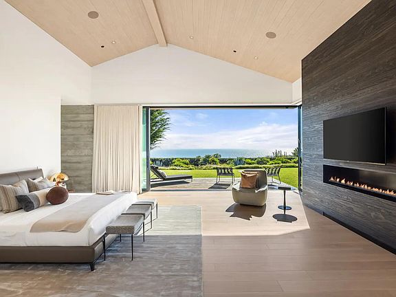 Indulge in luxury as you explore a spacious bedroom, complete with a cozy fireplace, smart TV, and an exclusive terrace.