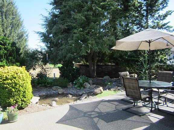 Water Feature : A small pond and running stream offer a serene setting for outdoor entertaining.