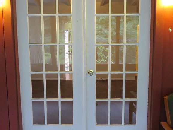 French doors enter screened patio