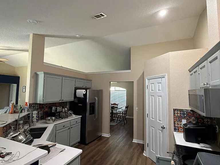Spacious kitchen with ample cabinet storage, generous counters, and an open pass-through to the dining area.