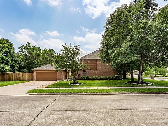 A long ample driveway framed by new fencing, with no neighbors on one side or behind this home are an added bonus to living on this large corner lot.