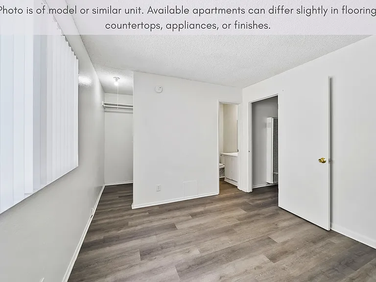 Comfortable bedroom with modern flooring, generous closet space, and natural light.