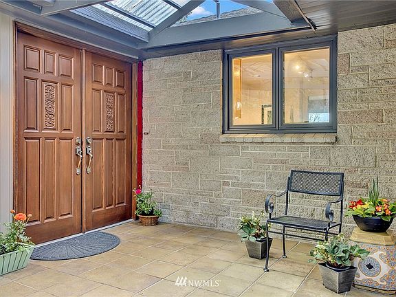 Protected front entry ,tile floor, new roof 2014. Home painted 2016. House faces East, door faces North.